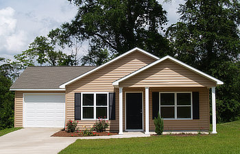 one story residential low income home with vinyl siding on the facade